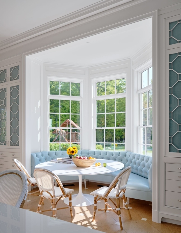 Bright Breakfast Nook: Blue Tufted Banquette in Bay Window