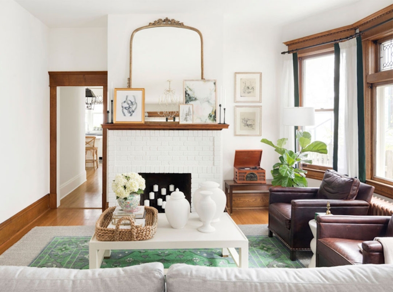 Bright Living Room with White Painted Brick Fireplace & Arched Mirror