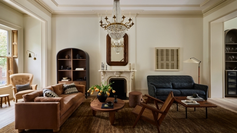 Brownstone Living Room With Arched Bookshelf And Classic Marble Fireplace