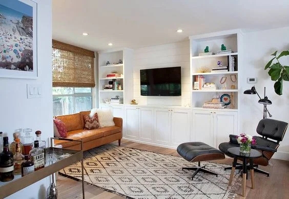 Built-in Bookcase surrounding a White Shiplap TV Wall Feature.
