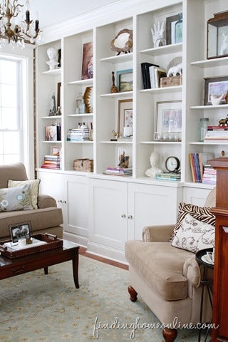 Built-in Bookcase: Traditional Wall-to-Wall White Shelving and Trim.