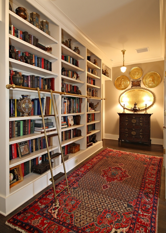 Built-in Bookcase with Sliding Brass Ladder and Oriental Rug