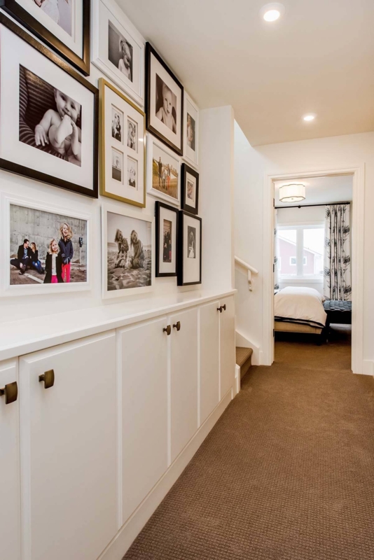 Built-In Hallway Cabinetry with Large Gallery Wall & Carpet