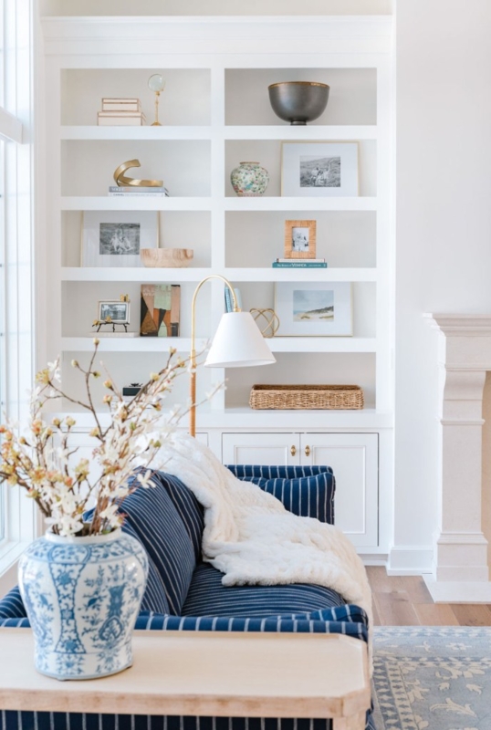 Built-in Shelving in Coastal Living Room with Navy Striped Sofa.