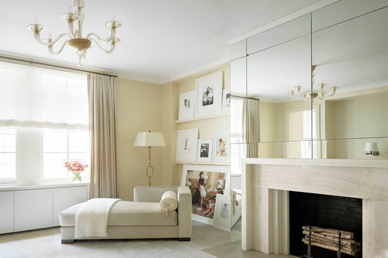 Chaise Lounge in Monochromatic Nook with Paneled Mirror Wall over Mantel.