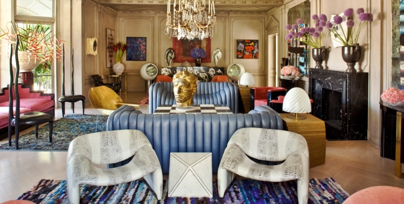 Channeled Blue Sofa with Black Marble Fireplace & Crystal Chandelier