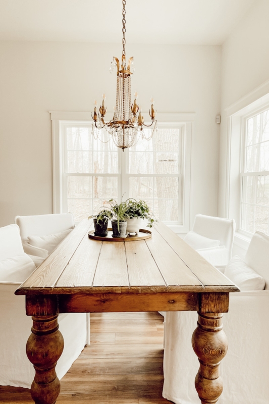 Charming French Country Dining Room with slipcovered chairs.