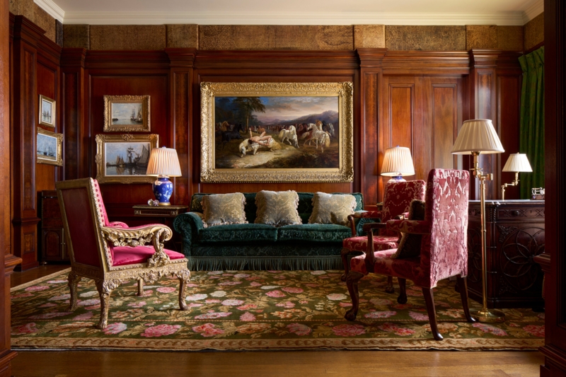 Classic Wood Paneled Study: Green Velvet Sofa & Ornate Floral Rug