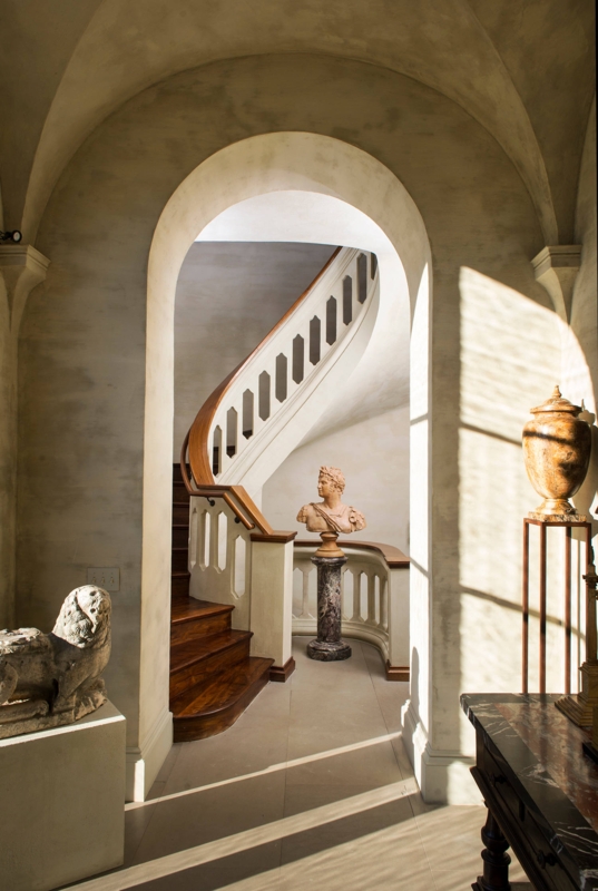 Classical Villa Entryway with Sweeping Spiral Staircase & Arches