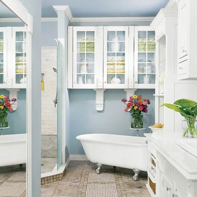 Clawfoot Bathtub in Cottage Bathroom with Glass-Front Cabinets