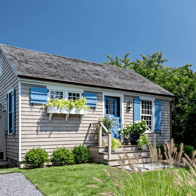 Coastal Cottage Exterior Design with Light Blue Shutters