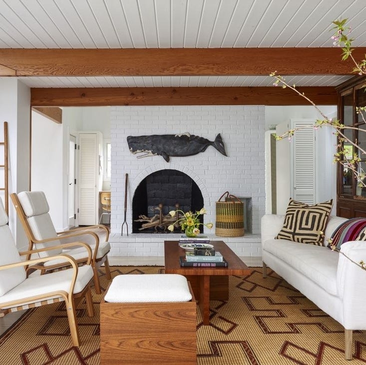 Coastal Living Room Featuring Arched Brick Fireplace and Whale Art