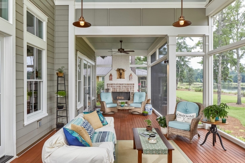 Coastal Porch with Brick Fireplace, Red Wood Floors & Wicker Furniture.