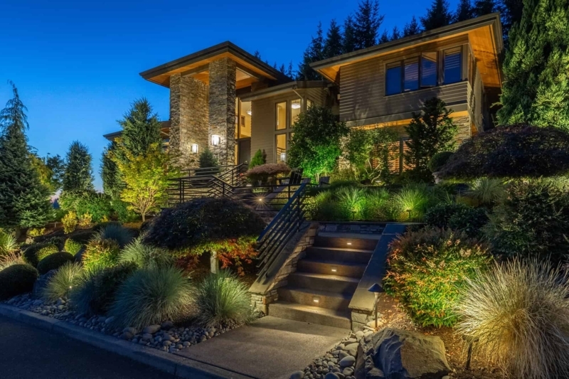 Contemporary Home Exterior with Recessed Stair Lighting and Stone Cladding