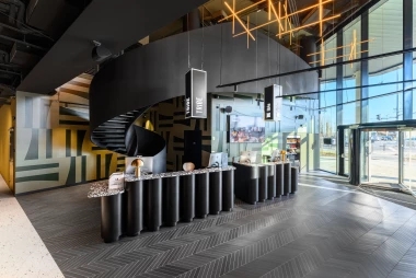Contemporary Lobby Design: Black Spiral Staircase, Fluted Reception Desk