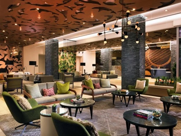 Contemporary Lounge: Cutout Ceiling, Stacked Stone Columns, Green Chairs
