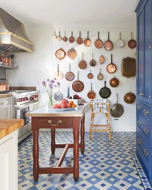 Copper Cookware Pegboard Wall with Blue Pantry and Geometric Tile Floor