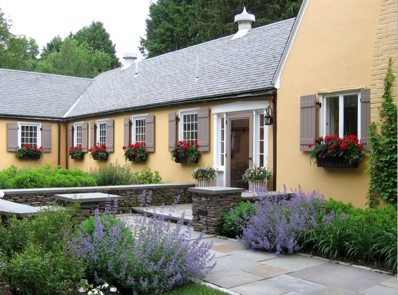 Cottage Garden With Red Window Boxes & Ochre Walls
