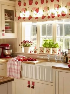 Cottage Kitchen with Strawberry Motif, Red Stand Mixer, and Fluted Sink