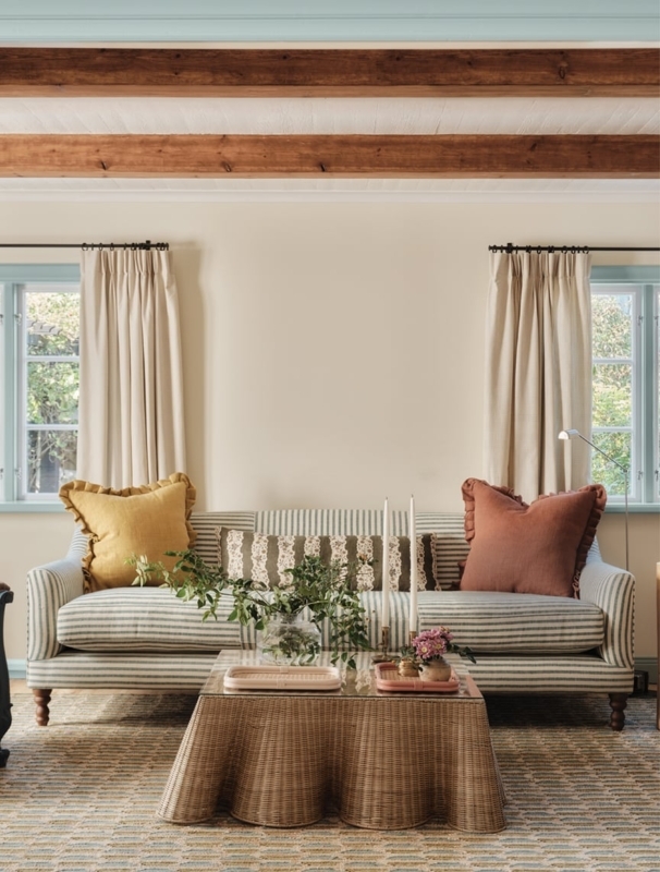 Cottagecore Living Room: Scalloped Wicker Table & Exposed Beams