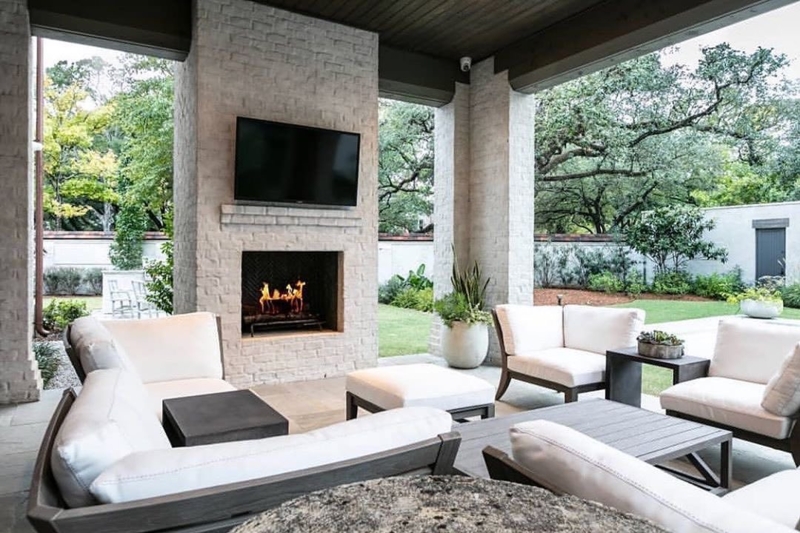 Covered Patio featuring Whitewashed Stone Fireplace with TV Mount