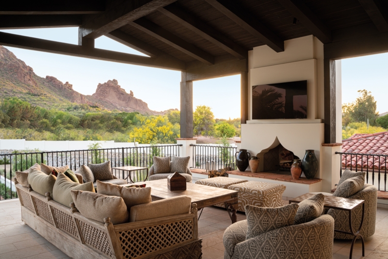 Covered Patio Lounge with Arched Adobe Fireplace and Mountain View
