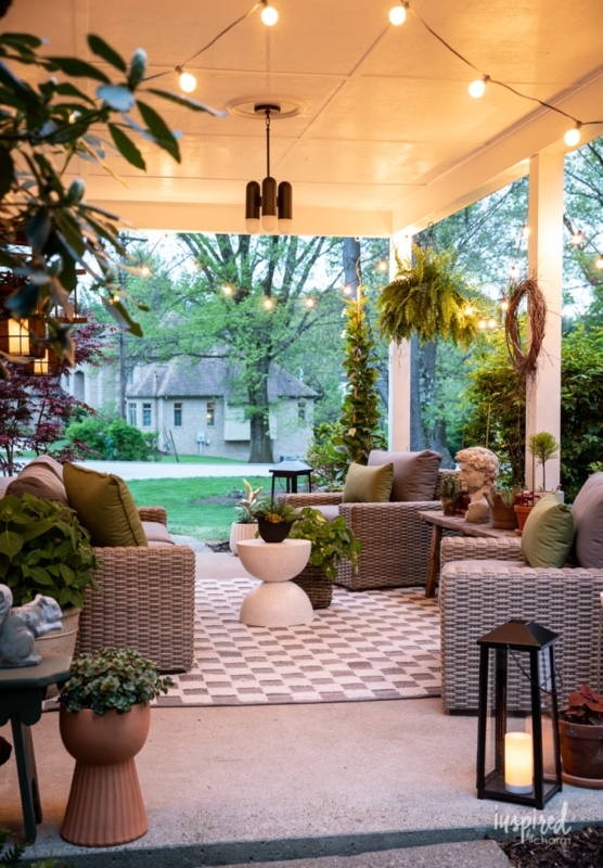Covered Porch Seating with Checkered Rug and Layered String Lighting