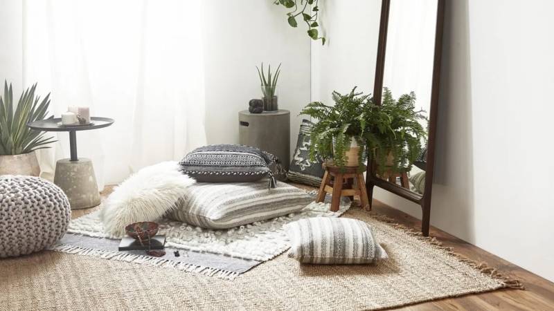 Cozy Floor Seating Nook with Layered Rugs and Leaning Mirror