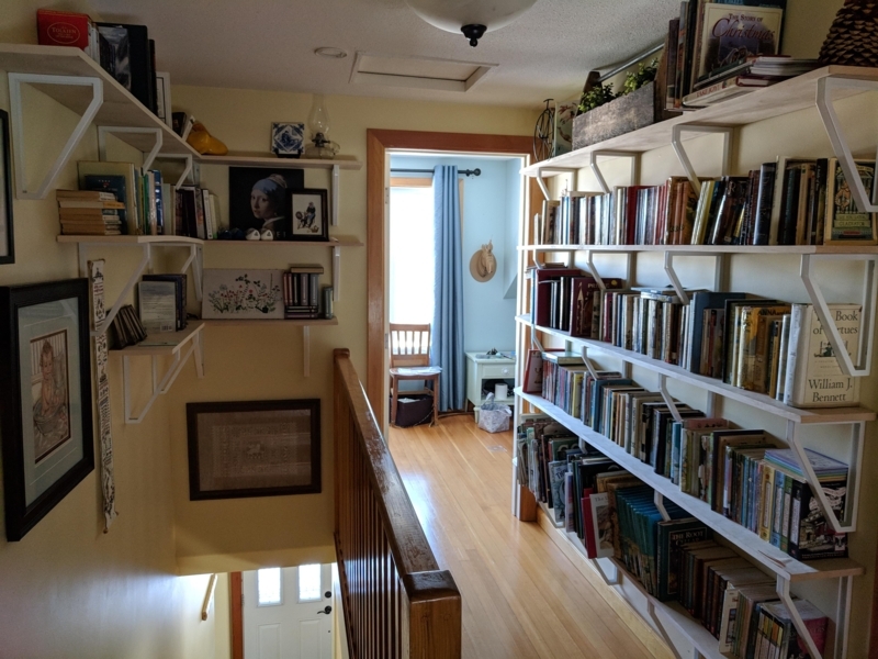 Cozy Hallway Library featuring Wraparound Wall Mounted Shelving