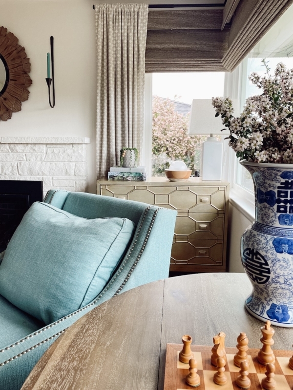 Cozy Living Room Nook: Teal Armchair & Nailhead Trim