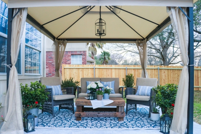 Cozy Patio Conversation Set under Gazebo with Sheer Curtains and Rug