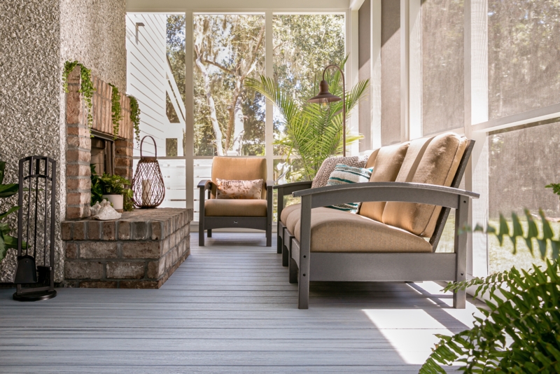 Cozy Porch with Brick Hearth, Gray Composite Decking & Neutral Seating.
