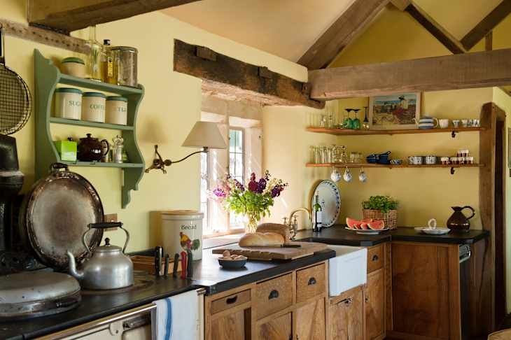Cozy Yellow Kitchen Scene with Exposed Wood Beams and Green Wall Hutch