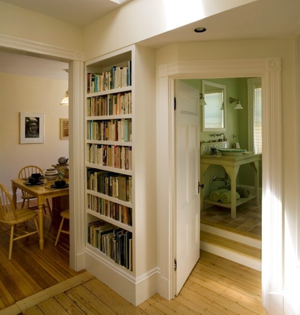 Cream Recessed Built-In Bookshelves with Elevated Bathroom Entry