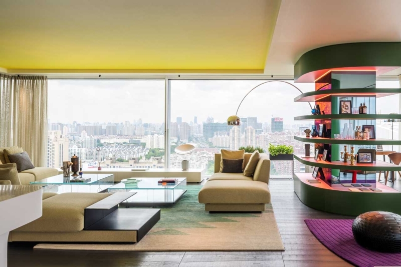 Curved Green Room Divider Shelves in Apartment with Yellow Ceiling