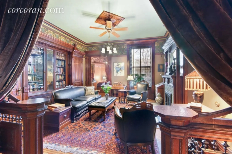 Dark Wood Paneling Victorian Parlor With Floor To Ceiling Bookshelves