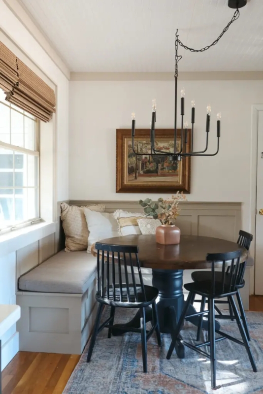 Dining Nook featuring Black Candle Style Chandelier