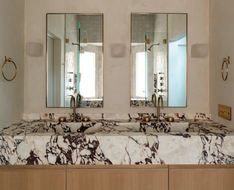 Double Vanity with Integrated Stone Sinks and Plaster Wall Finish