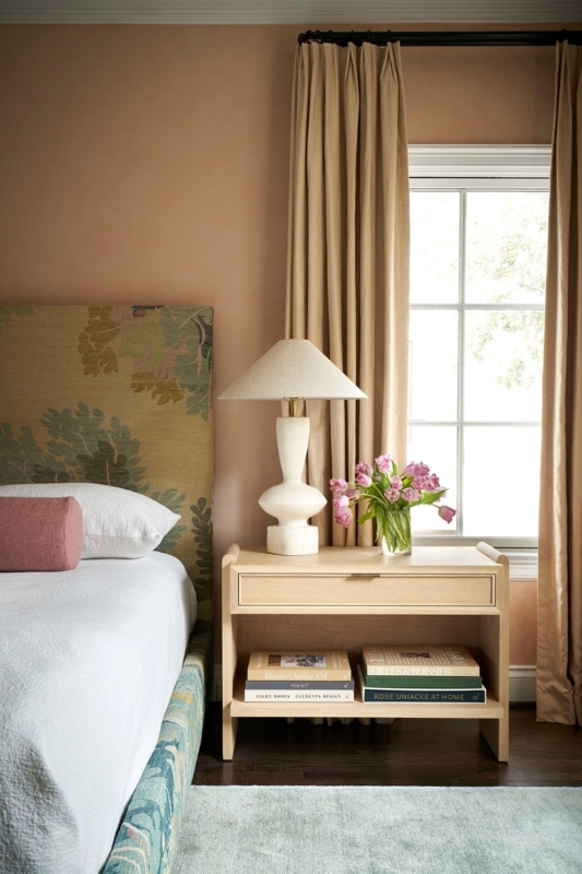Earthy Bedroom with Terracotta Walls, Sculptural Lamp & Botanical Bed