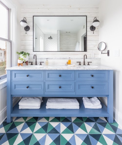 Eclectic Bathroom with Bold Blue Cabinetry and Triangular Patterned Floor Tiles