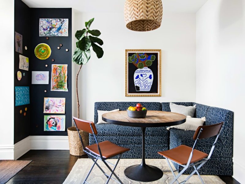 Eclectic Dining Nook with Patterned Banquette and Black Art Wall