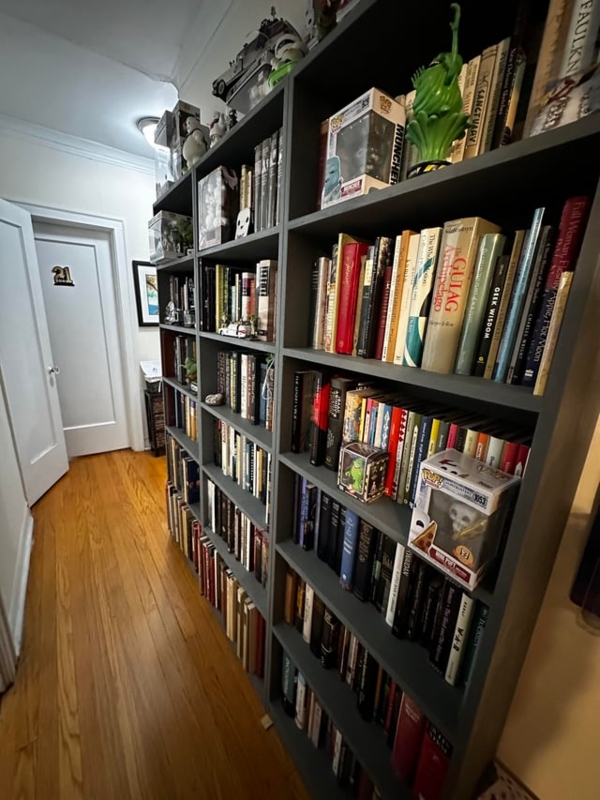 Eclectic Hallway with Tall Dark Gray Finish Bookcases