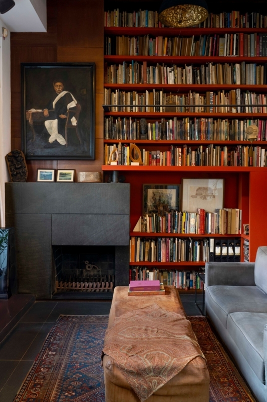Eclectic Home Library with Bold Red Floor-to-Ceiling Shelving