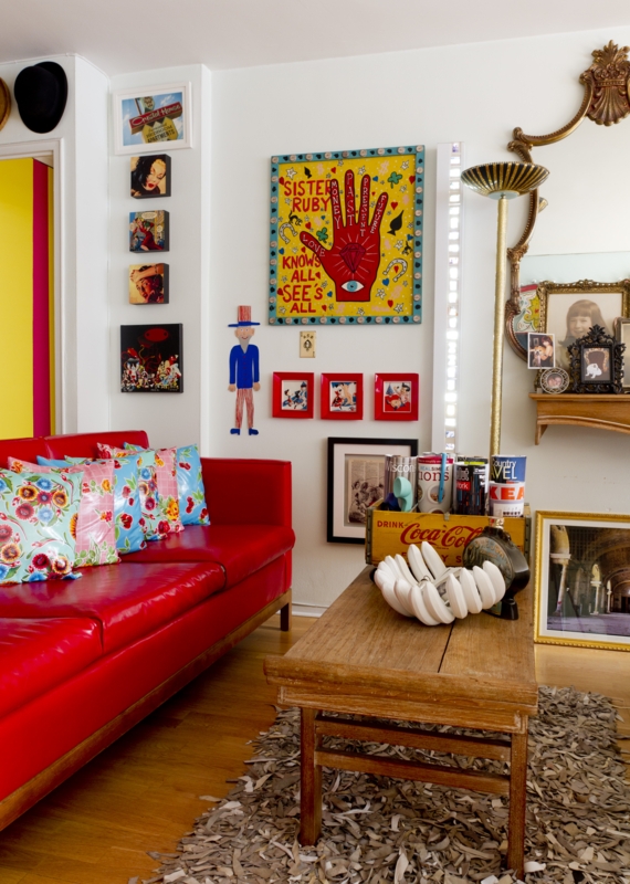 Eclectic Living Room Gallery Wall with Red Leather Sofa and Shag Rug