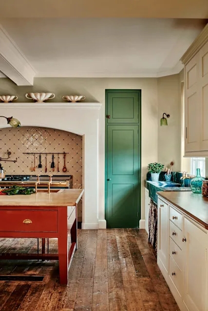 Eclectic Rustic Kitchen with Red Island and Green Pantry Door