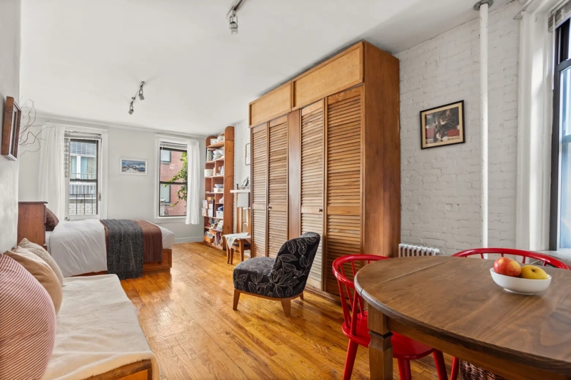 Eclectic Studio Apartment with a White Brick Wall