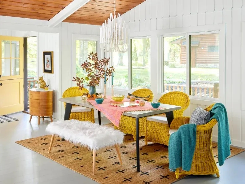 Eclectic Sunroom Dining Room with Yellow Woven Chairs