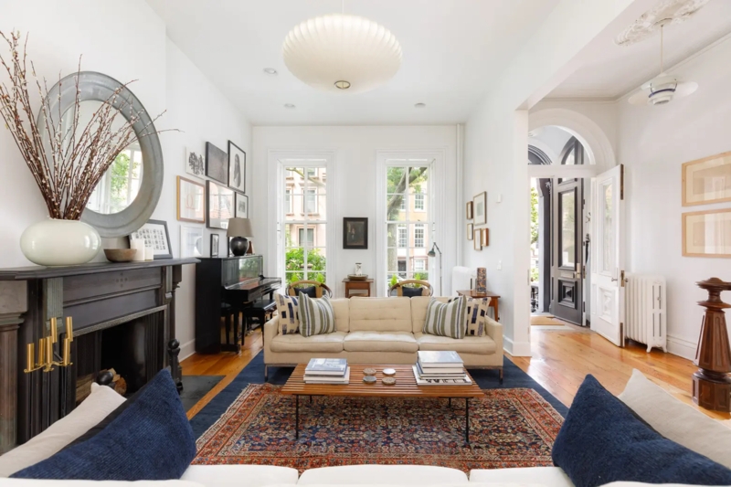 Eclectic Townhouse Living Room: Layered Rugs & Slatted Coffee Table