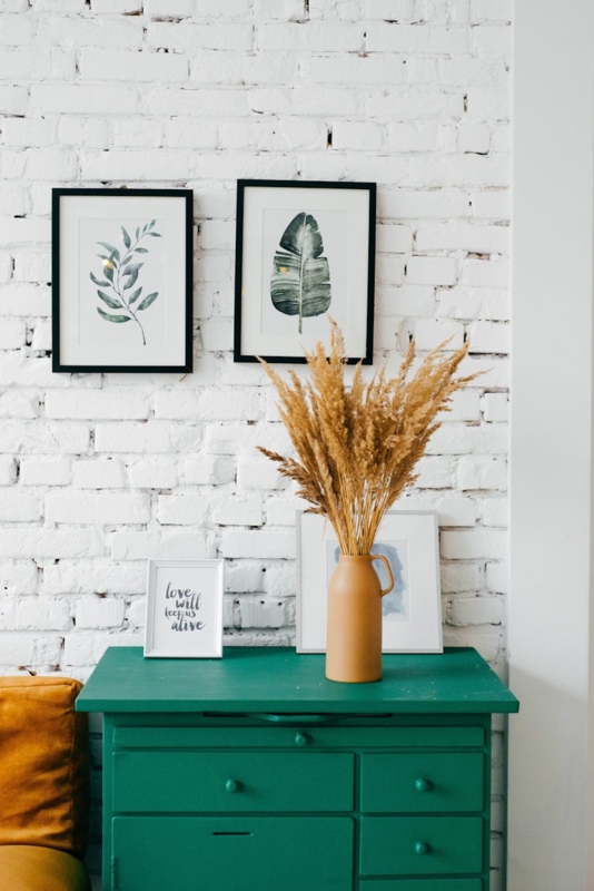 Emerald Green Dresser Styling Ideas against White Brick Wall