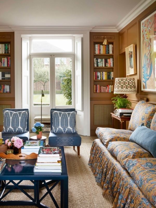 English Country Living Room with Ochre Paneling and Skirted Floral Sofa